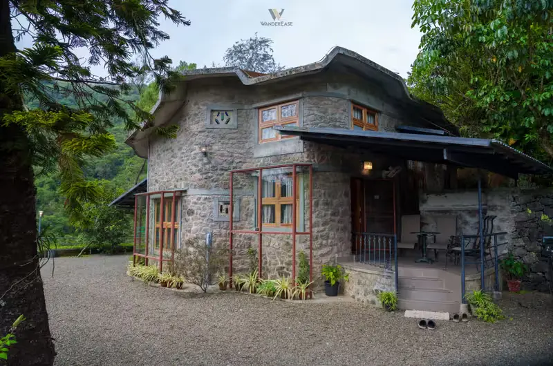 Stone cottage exterior with stone masonry walls and lush green surroundings at Stone Haven by Wanderease