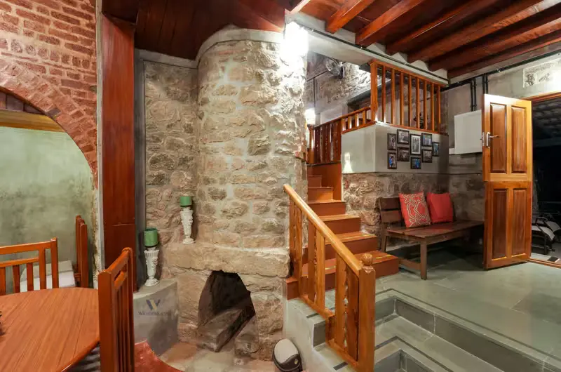 Cozy rustic interior with stone wall architecture at Stone Haven by Wanderease Vagamon