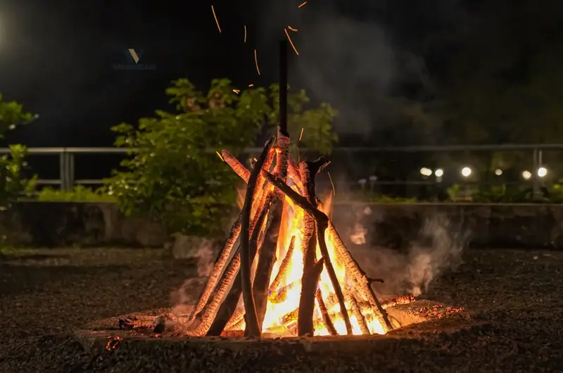 Outdoor campfire setup lit up at night at Stone Haven by Wanderease