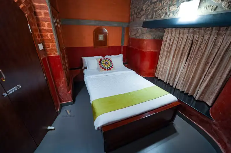 Cozy single bedroom suite with warm lighting and stone walls at Stone Haven by Wanderease