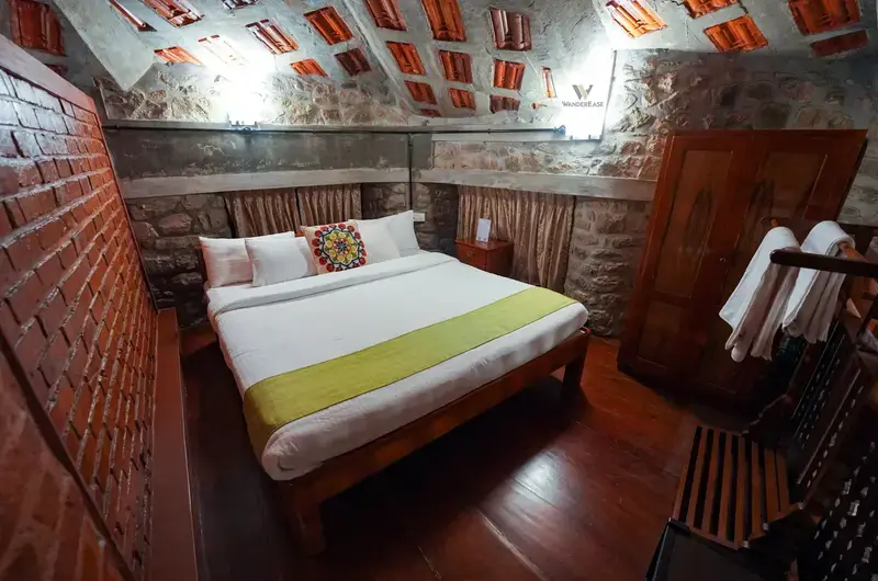 double bedroom suite with exposed brick ceiling and stone walls at Stone Haven by Wanderease