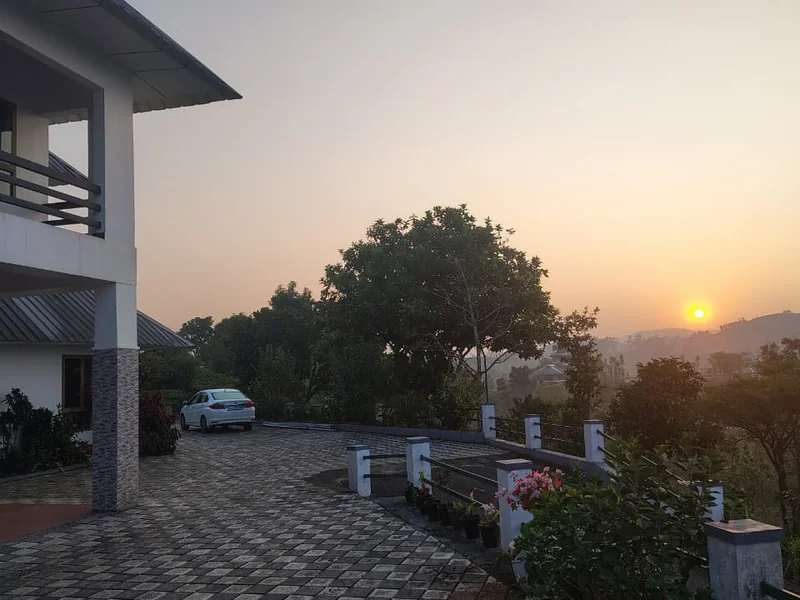 Private balcony at Zen Garden Wellness Homestay with scenic sunset views in Vagamon