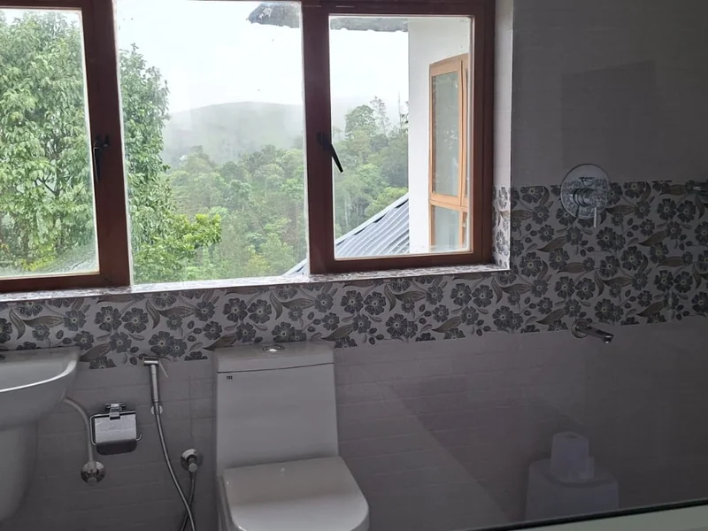 Modern ensuite bathroom with tile finishes at Zen Garden Wellness Homestay Vagamon