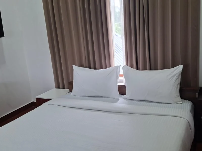 Spacious bedroom suite with plush double bed at Zen Garden Wellness Homestay Vagamon