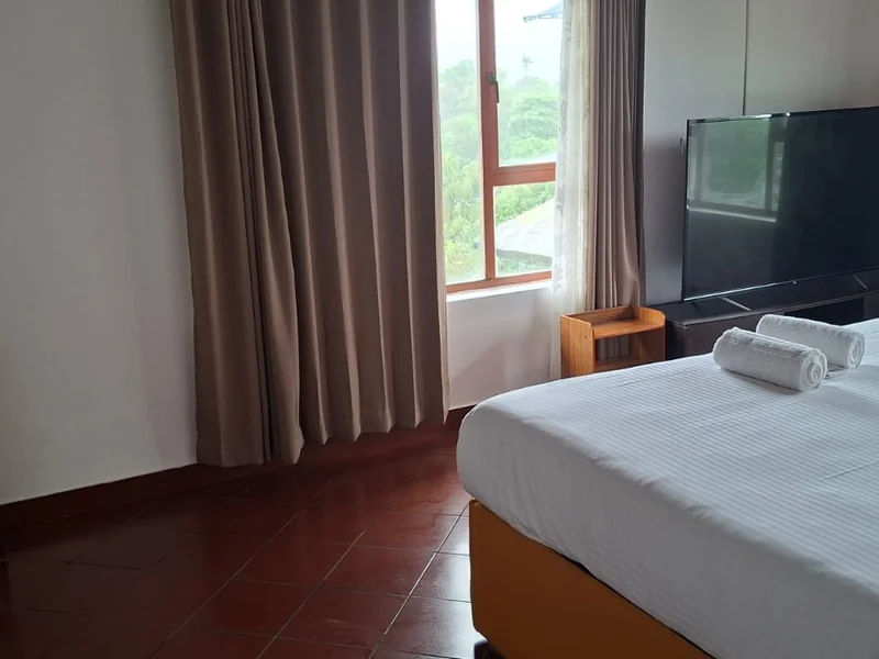 Cozy homestay bedroom with large scenic window at Zen Garden Wellness Homestay Vagamon