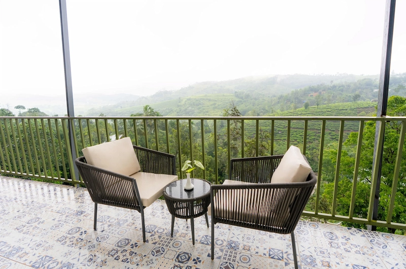 Outdoor patio seating area overlooking green mountain valley views at Santuario Resort Vagamon