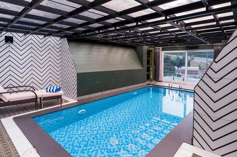 Santuario Resort indoor swimming pool with covered roof structure in Vagamon