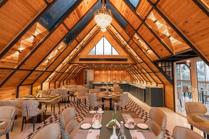 Warmly lit interior lounge with wooden A-frame architecture at Santuario Resort Vagamon
