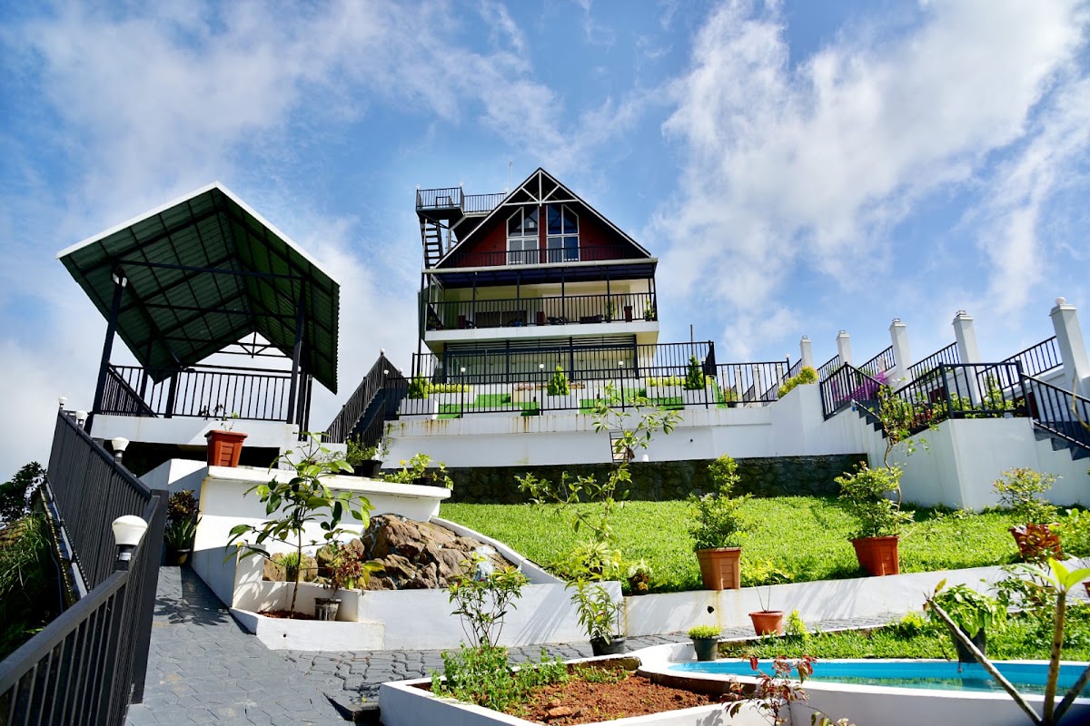 Exterior view of ODMOR Resort Vagamon nestled on a hillside with scenic mountain surroundings