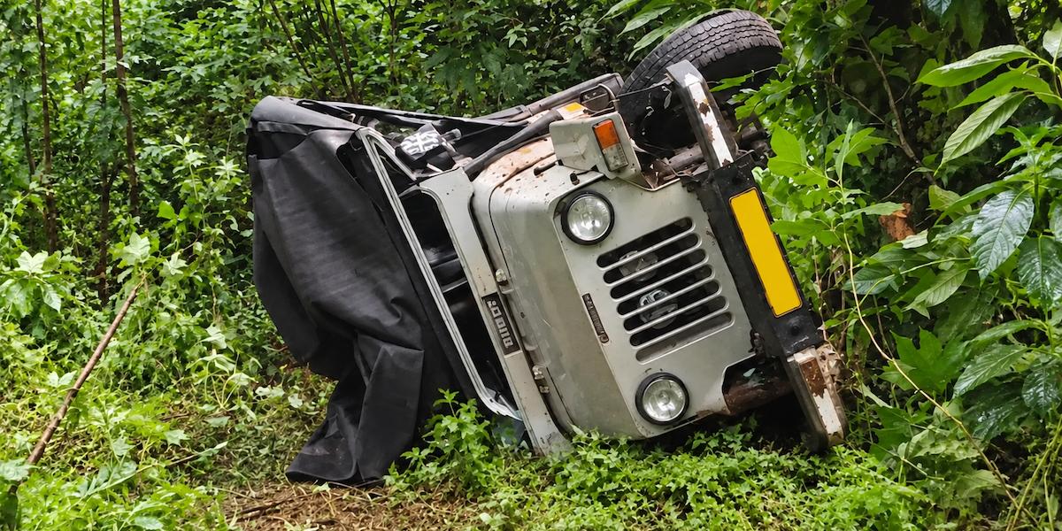 Overturned off-road tourist jeep lying on its side after accident in Vagamon