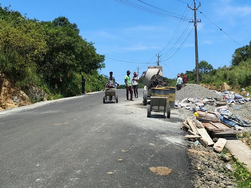 road section undergoing repair with roadside debris on Vagamon hill route